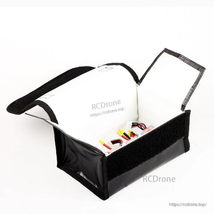 Open battery safe bag angled view showing insulated white lining and RC LiPo battery leads inside