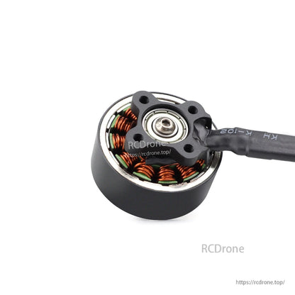 Bottom view showing motor base, bearing, mounting holes, and soldered wire lead