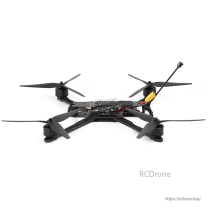 Rear/low angle view of quad frame showing four motors, props, and top plate electronics layout