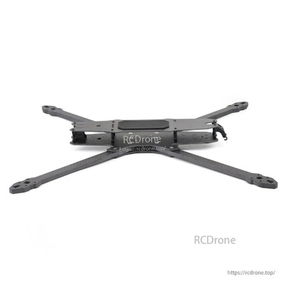Side profile of assembled FPV frame showing low-slung center stack and carbon fiber arms