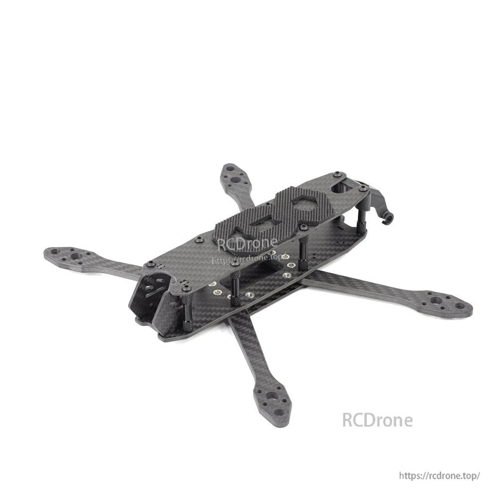 Angled rear-quarter view of assembled carbon fiber FPV quad frame with standoffs and top plate
