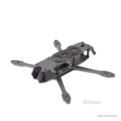 Angled rear-quarter view of assembled carbon fiber FPV quad frame with standoffs and top plate