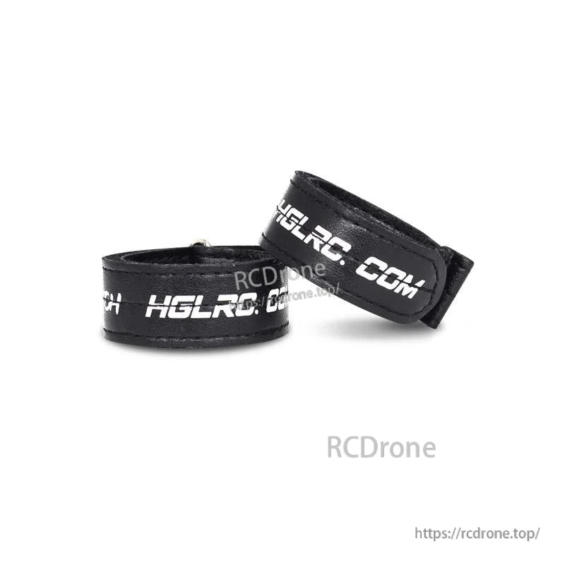 Rolled black hook-and-loop battery straps showing thickness and stitched edges
