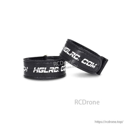 Rolled black hook-and-loop battery straps showing thickness and stitched edges