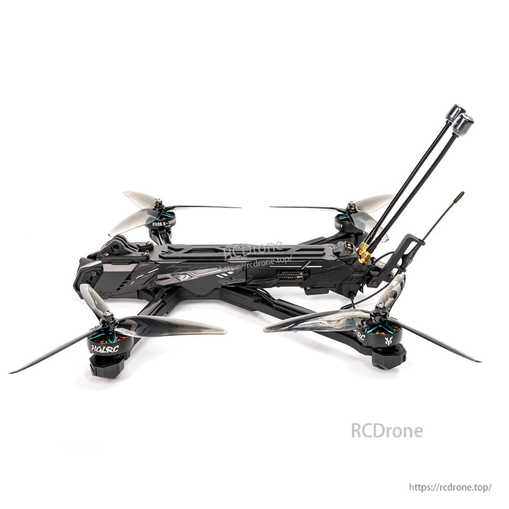 Side profile of FPV quadcopter showing long top plate, motor arms, prop clearance and rear antenna assembly