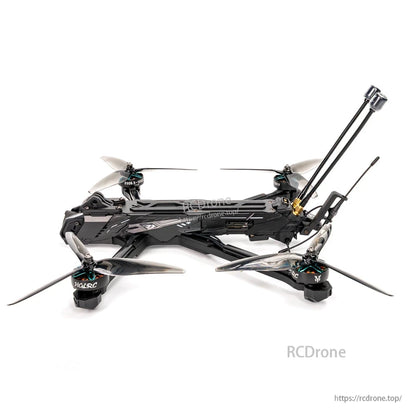 Side profile of FPV quadcopter showing long top plate, motor arms, prop clearance and rear antenna assembly