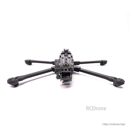Rear view of assembled frame with arms spread, showing back plate and tail section