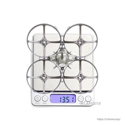 Whoop frame on digital scale showing 13.51 g weight with canopy installed
