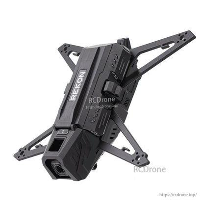 Angled close view of frame top shell with REKON logo, front camera opening and carbon fiber arms