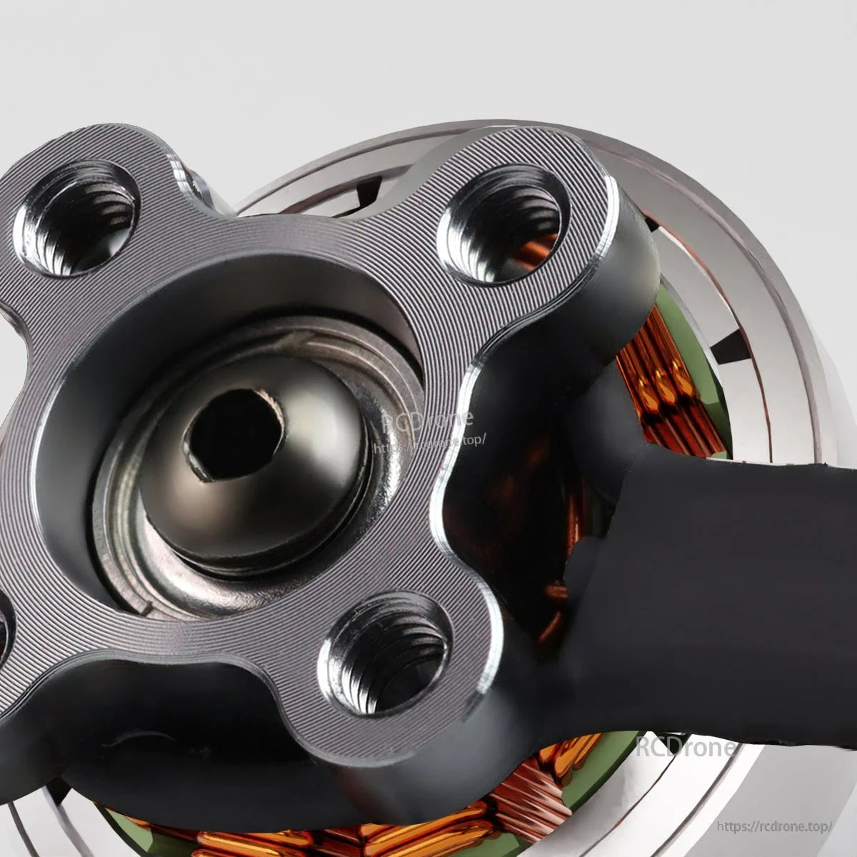 Close-up of motor base showing threaded mounting holes and central bearing cap detail