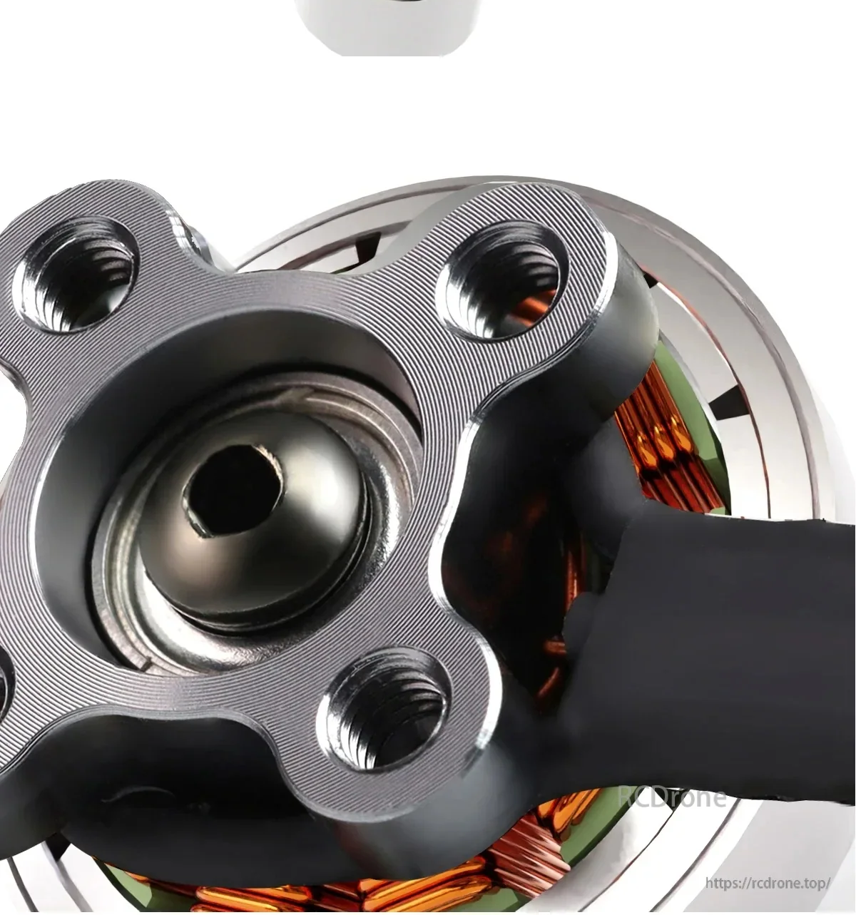 Close-up of motor base with four mounting holes and center bearing seat detail