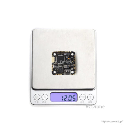 SPECTER 25A AIO board on digital scale showing 12.05 g weight display