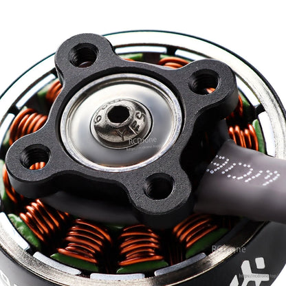 Close-up of motor base mount and center screw, showing four mounting holes and copper stator coils
