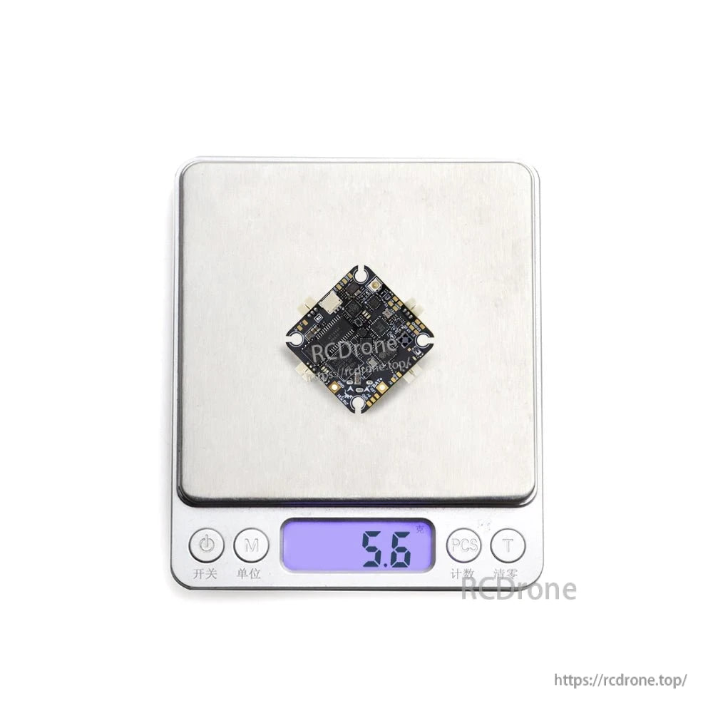 Flight controller shown on digital scale displaying 5.6 g weight