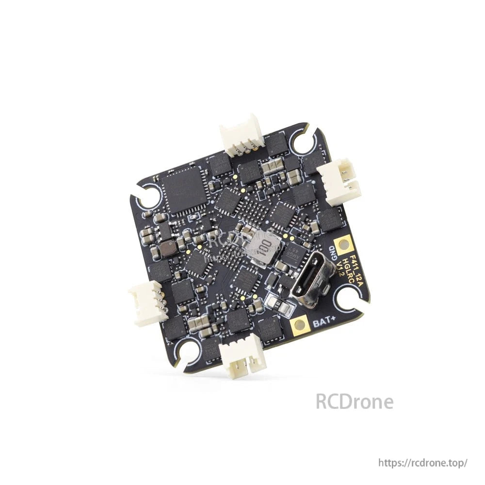 Angled close-up of flight controller PCB with USB-C connector, BAT+ pad, and plug sockets