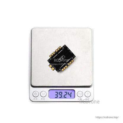 HGLRC SPECTER F760 BOX integrated stack on digital scale showing weight reading 38.24 g