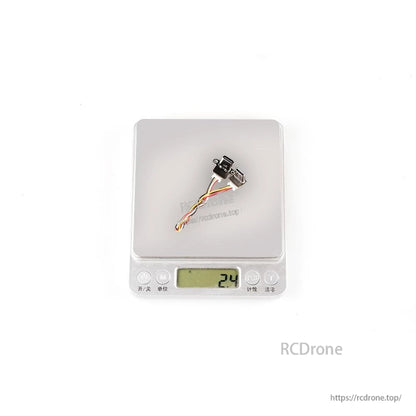 Tuning adapter module with cable on digital scale showing 24 reading