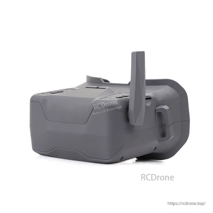 Rear side view of FPV goggle with upright antenna, showing shell contours and strap slot