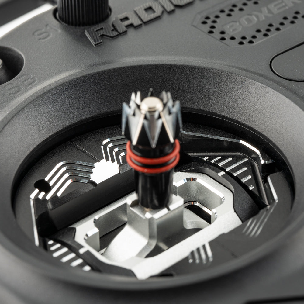 Close-up of RC transmitter gimbal joystick with installed metal spacer around the stick opening