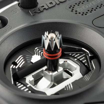 Close-up of RC transmitter gimbal joystick with installed metal spacer around the stick opening