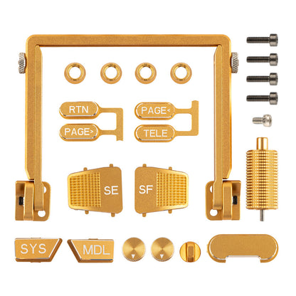 Gold anodized CNC upgrade parts kit layout with frame bracket, button caps, thumb paddles, knob, and screws