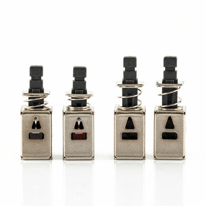 Four metal replacement switch modules lined up, front view showing rectangular and triangular cutout slots