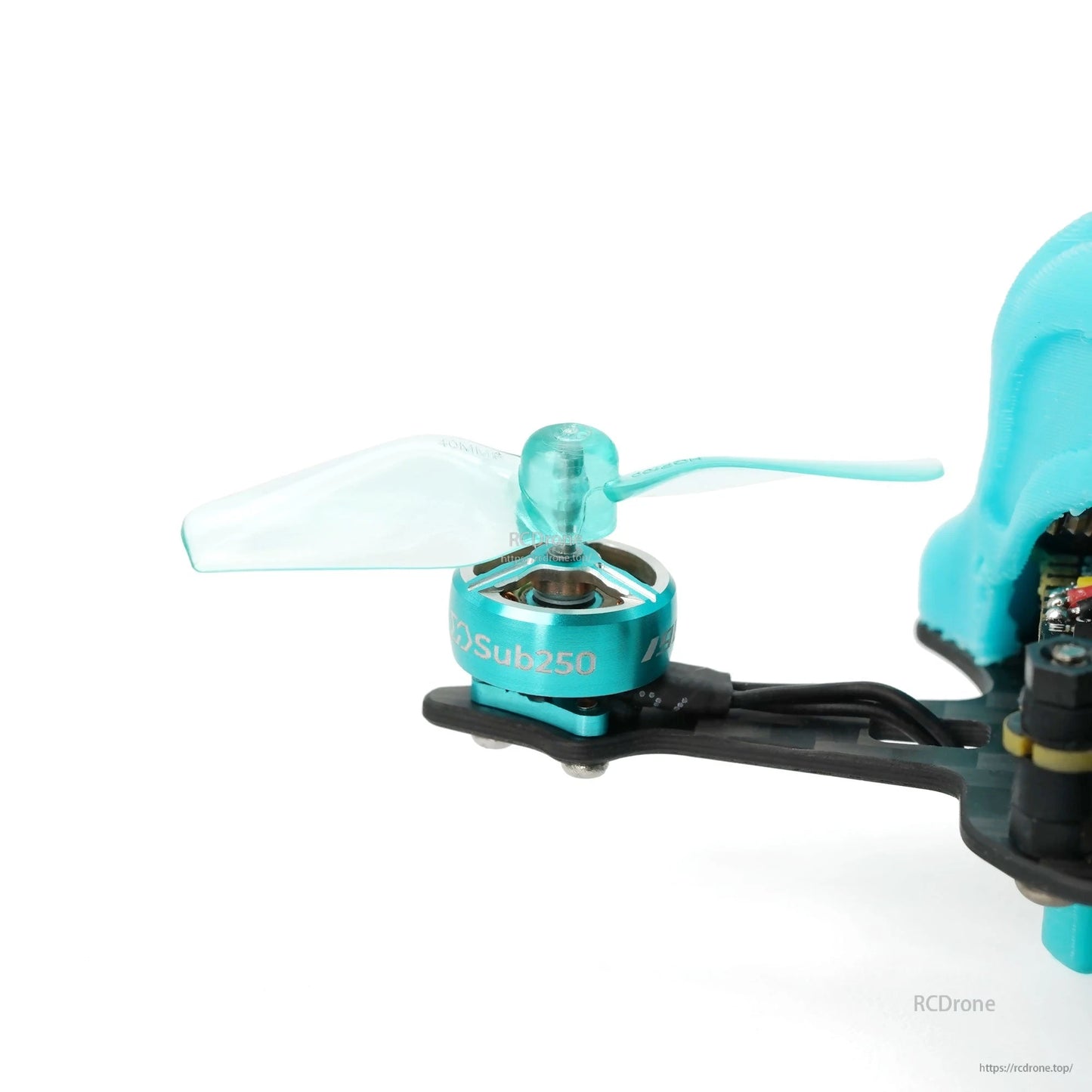 Translucent aqua 2-blade propeller mounted on micro drone motor, side view on black frame arm