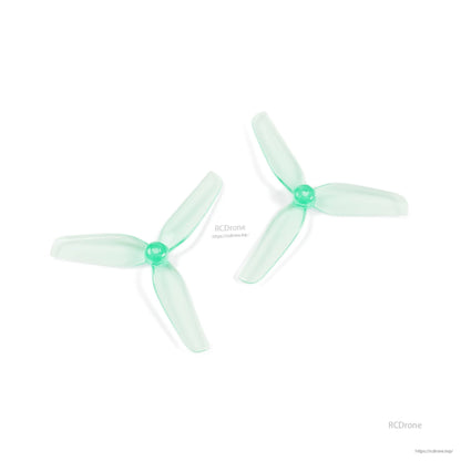 Two translucent aquamarine 3-blade drone propellers shown at angles to display blade profile