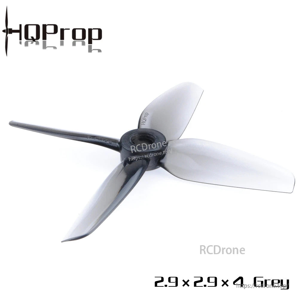 Single grey 4-blade polycarbonate drone propeller, angled view showing hub and blade shape