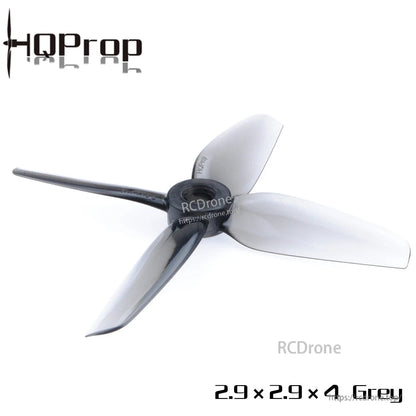 Single grey 4-blade polycarbonate drone propeller, angled view showing hub and blade shape