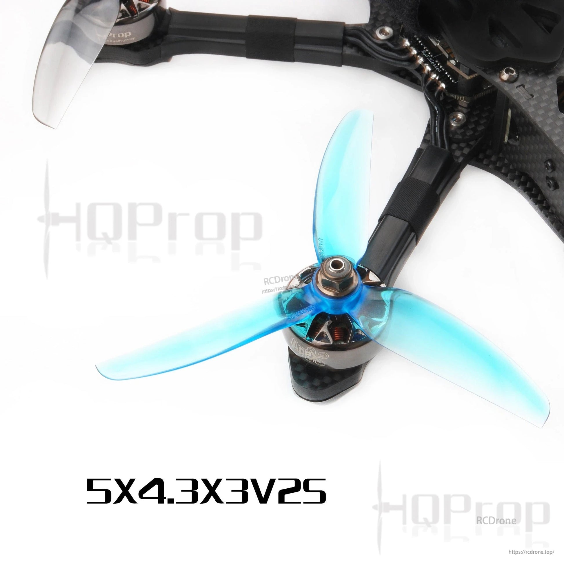 Blue 5-inch tri-blade prop mounted on FPV drone motor and arm, HQProp 5x4.3x3V2S