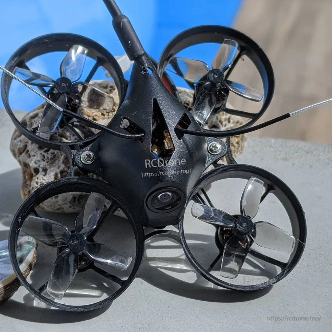 Translucent gray 4-blade props mounted on a black ducted micro whoop quadcopter