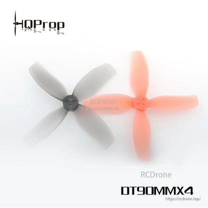 HQ Prop DT90MMX4 90mm 4-blade FPV drone propellers in grey and translucent orange with 4-hole hub