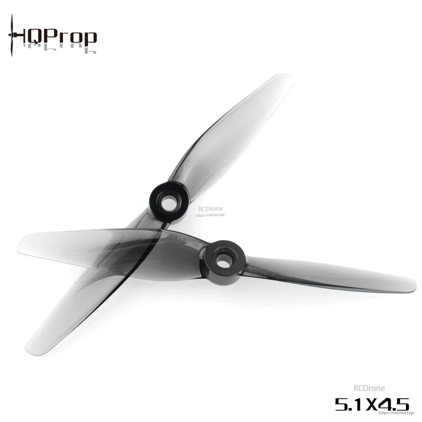 Two HQProp 5.1x4.5 grey two-blade propellers crossed, showing hub openings and blade profile