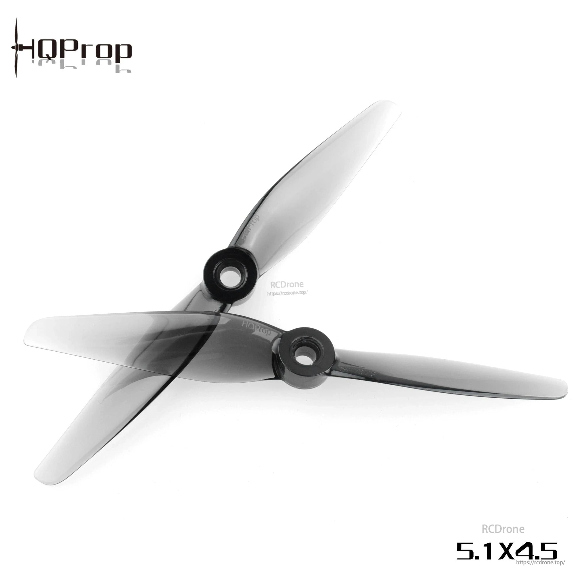 Two HQProp 5.1x4.5 grey two-blade propellers crossed, showing hub openings and blade profile