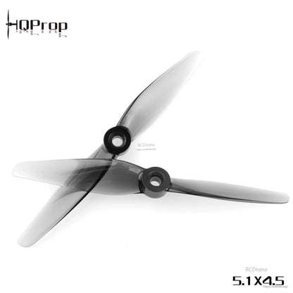 Two HQProp 5.1x4.5 grey two-blade propellers crossed, showing hub openings and blade profile