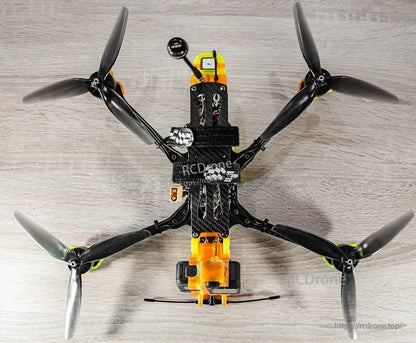 7-inch tri-blade propellers installed on an FPV quadcopter, top-down view showing all four rotors