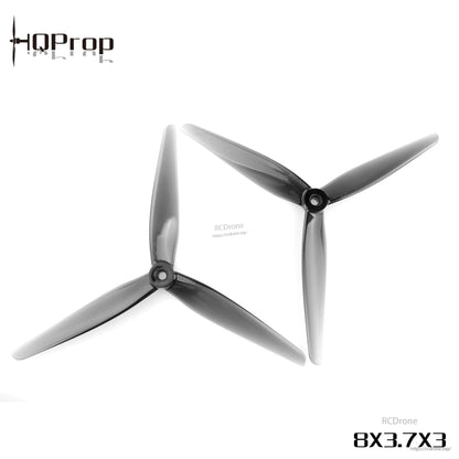Grey 8x3.7x3 three-blade propeller pair, angled top view showing hub and blade shape