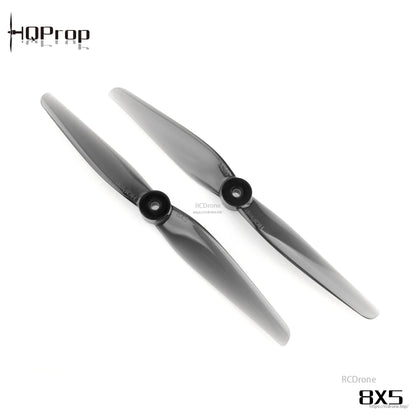 Pair of HQProp 8x5 2-blade propellers side by side, light grey polycarbonate, matching hubs