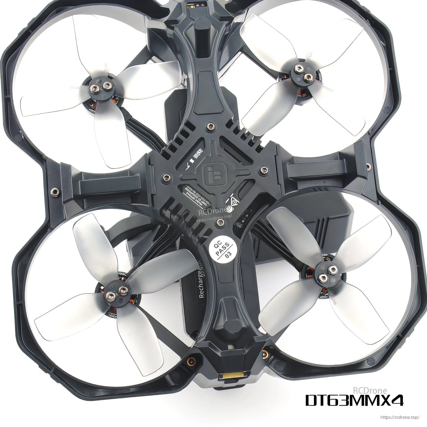 Top-down view of ducted quadcopter with four light grey 4-blade props inside protective ducts