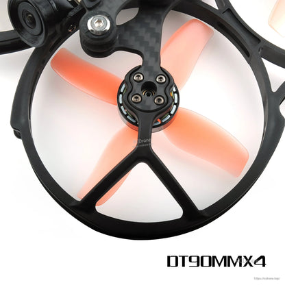 Orange 4-blade prop fitted in ducted cinewhoop frame with camera visible, top-down close-up