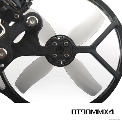 Grey 4-blade prop mounted in cinewhoop duct guard, hub and motor screw pattern close-up