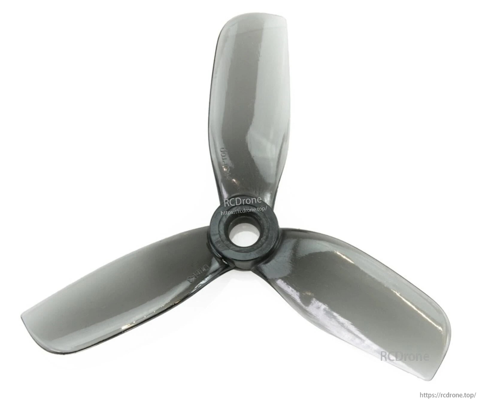 Smoke gray tri-blade propeller close-up with RCDRone watermark, centered hub and blade shape
