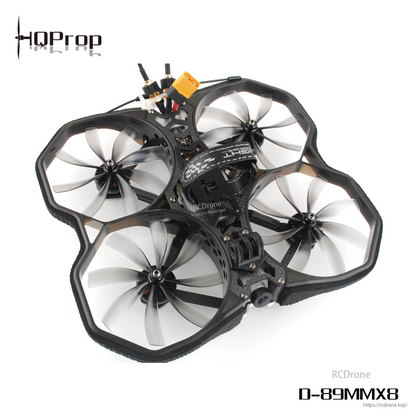 Cinewhoop drone frame fitted with four grey 8-blade ducted propellers, angled top view