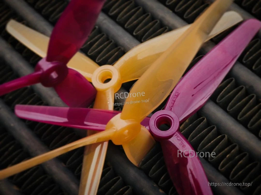 Close-up of Peanut Butter & Jelly tri-blade propeller hubs showing center bores and glossy finish