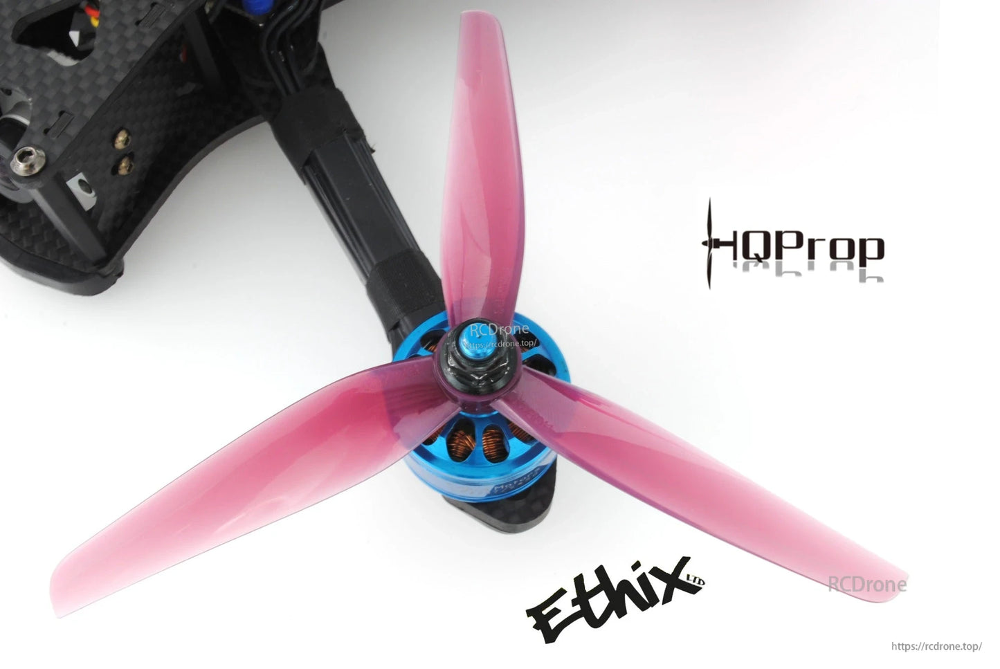Pink Ethix P3 3-blade propeller mounted on FPV drone motor, close-up of hub and blades