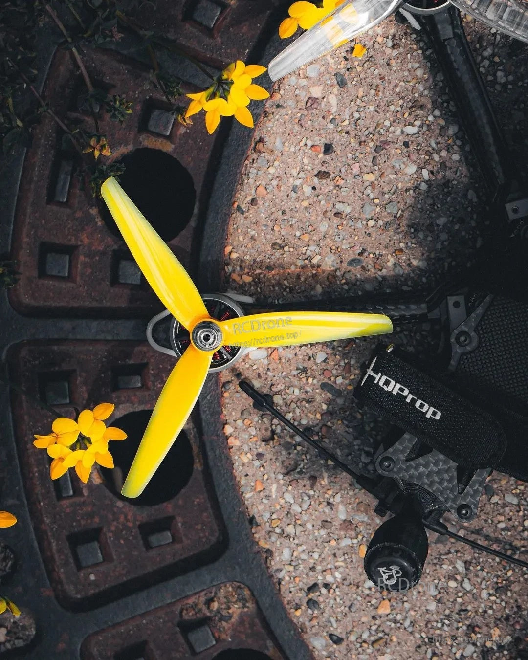 HQProp ETHIX P3.3 Mango Lassi 5.1in 3-blade polycarbonate FPV propeller mounted on a quad