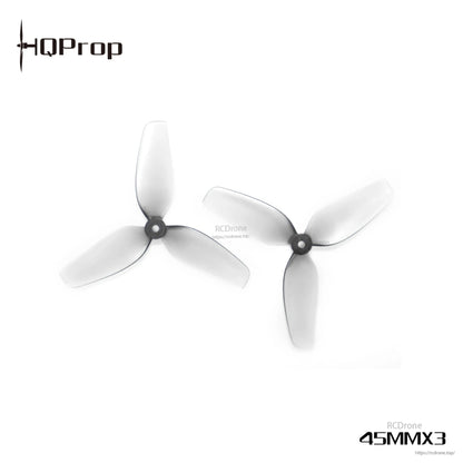 Close-up of two 45mm 3-blade micro whoop propellers showing hub and blade profile, translucent gray