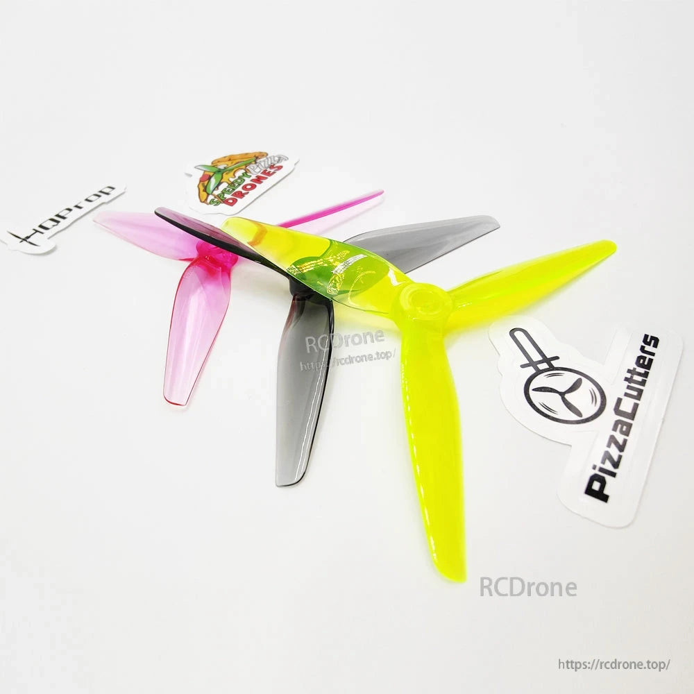 Angled close-up of stacked tri-blade propellers showing hub detail and translucent polycarbonate finish