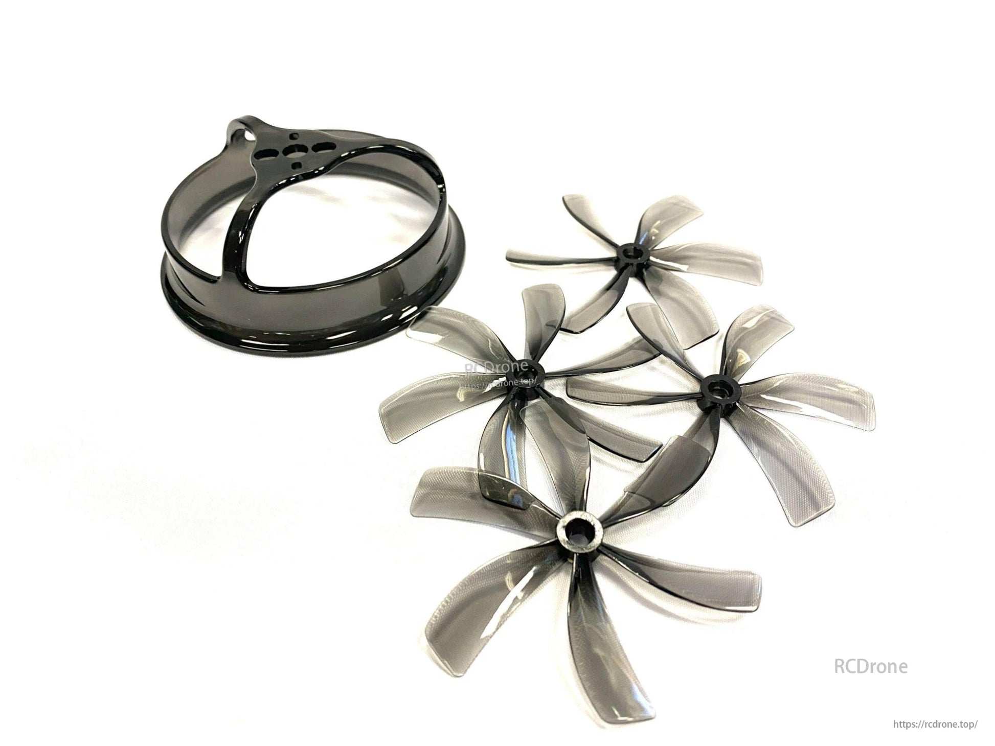 Four translucent 6-blade 85mm props with matching black duct shroud ring, angled view